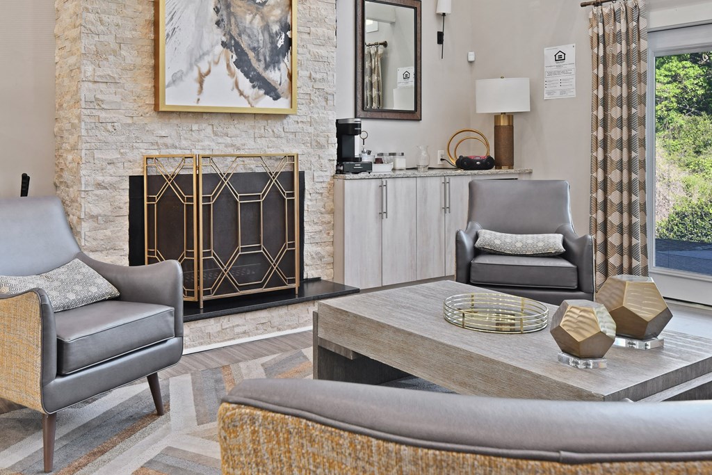 a living room with a fireplace and a coffee table at Premier Apartments, Georgia