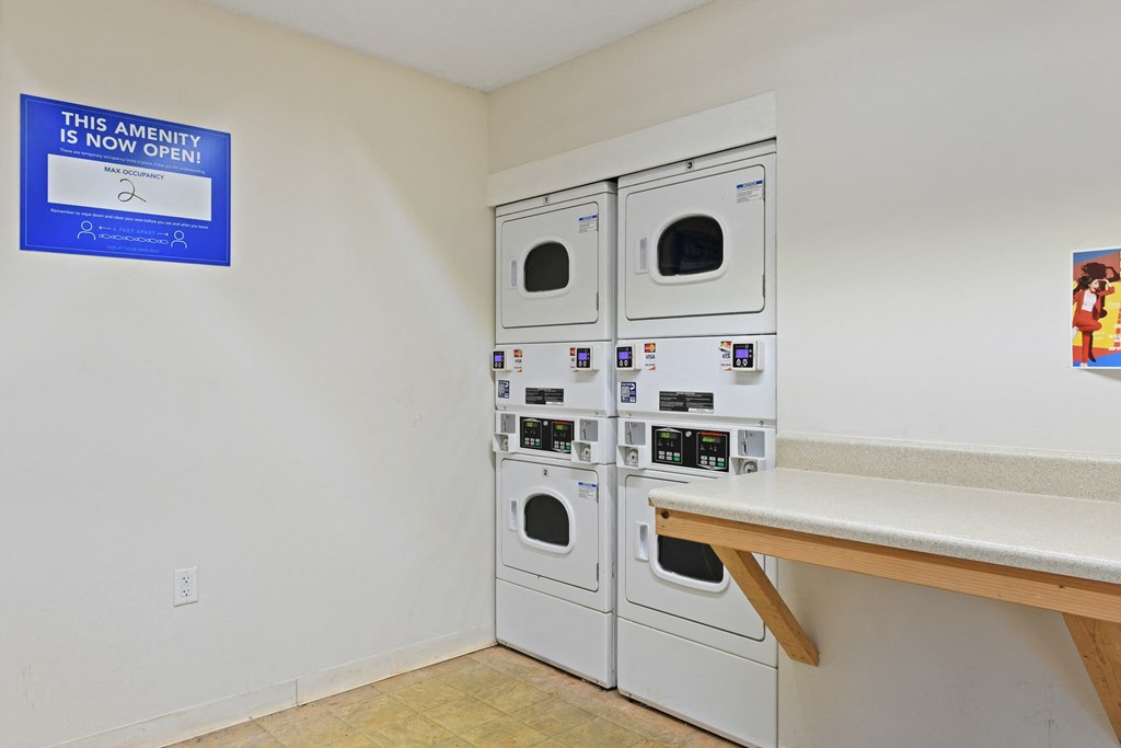 a laundry room with a bench and washer and dryer at Waldan Pond Apartments, Acworth, GA, 30102