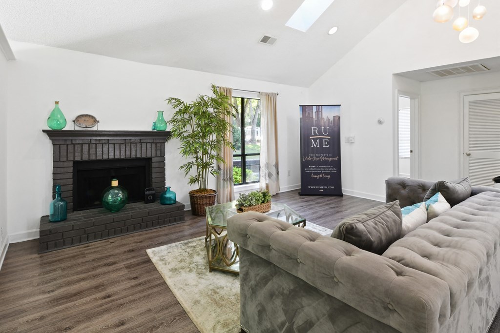 a living room with a fireplace and a couch at Waldan Pond Apartments, Acworth, GA, 30102