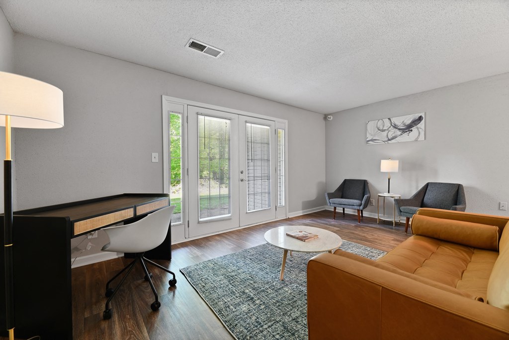 a living room with a couch and two chairs at Premier Apartments, Austell, 30168