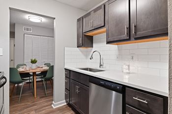 a kitchen and dining area in a 555 waverly unit at Premier Apartments, Austell