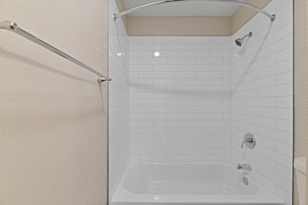 a bathroom with a shower and a bathtub at Premier Apartments, Georgia, 30168
