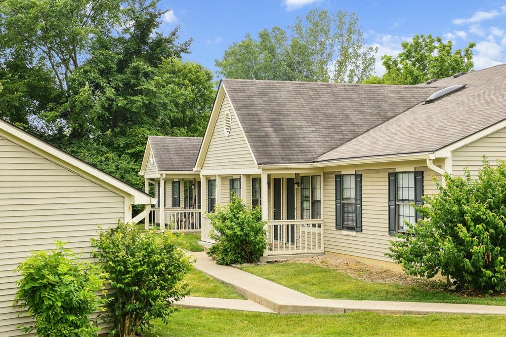 a house with a porch and a lawn at Oak Run Apartment Homes, Columbus