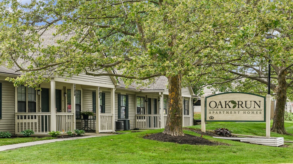 a picture of the oak run apartments sign in front of the building at Oak Run Apartment Homes, Columbus