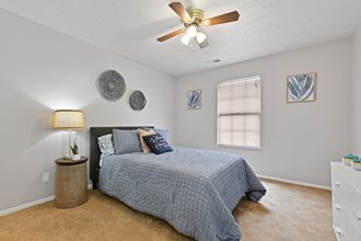 Large master bedroom with bright lights and ceiling fan at Oak Run Apartment Homes, Columbus, OH, 43228