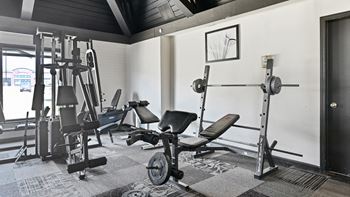 a gym with exercise equipment and a window