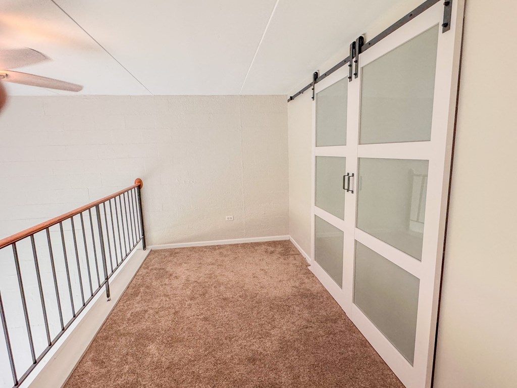 the upstairs bedroom has a door to the closet and a staircaseat Fox Run Apartments, St. Charles, IL, 60174