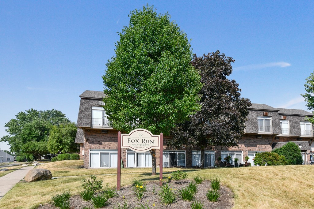 View with plenty of nature and greenery surrounding the building at Fox Run Apartments in St Charles IL 60174