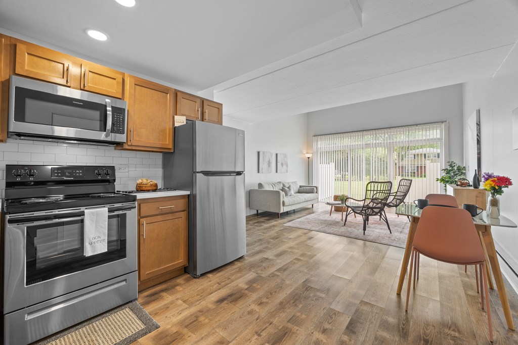 A modern kitchen with wooden cabinets and stainless steel appliances.