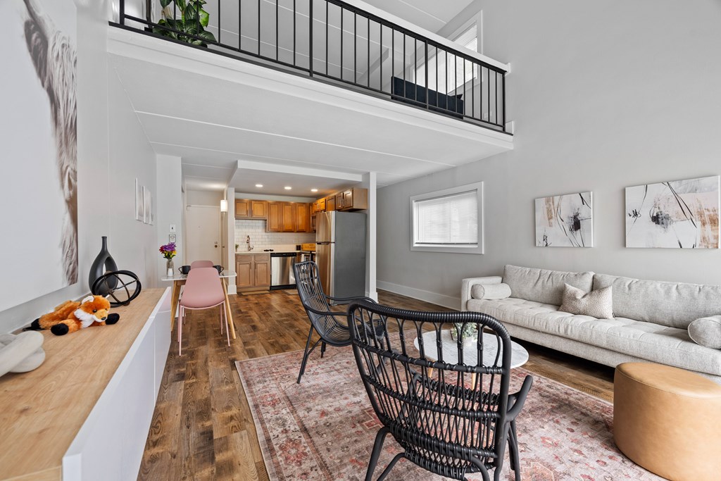 A living room with a black chair and a white couch.