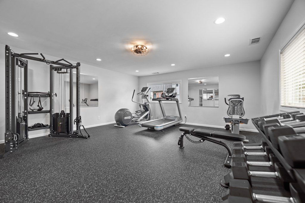 A spacious home gym with a variety of equipment.