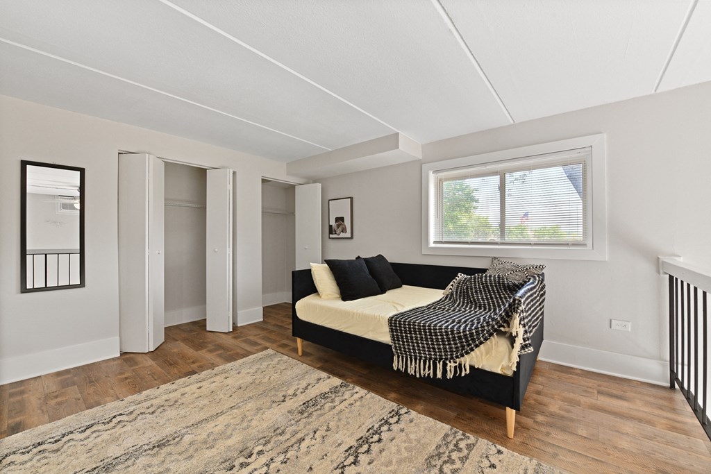 A large loft, perfect for a bedroom, guest room, or work from home office equipped with storage closets and natural light at Fox Run Apartments in St Charles IL 60174