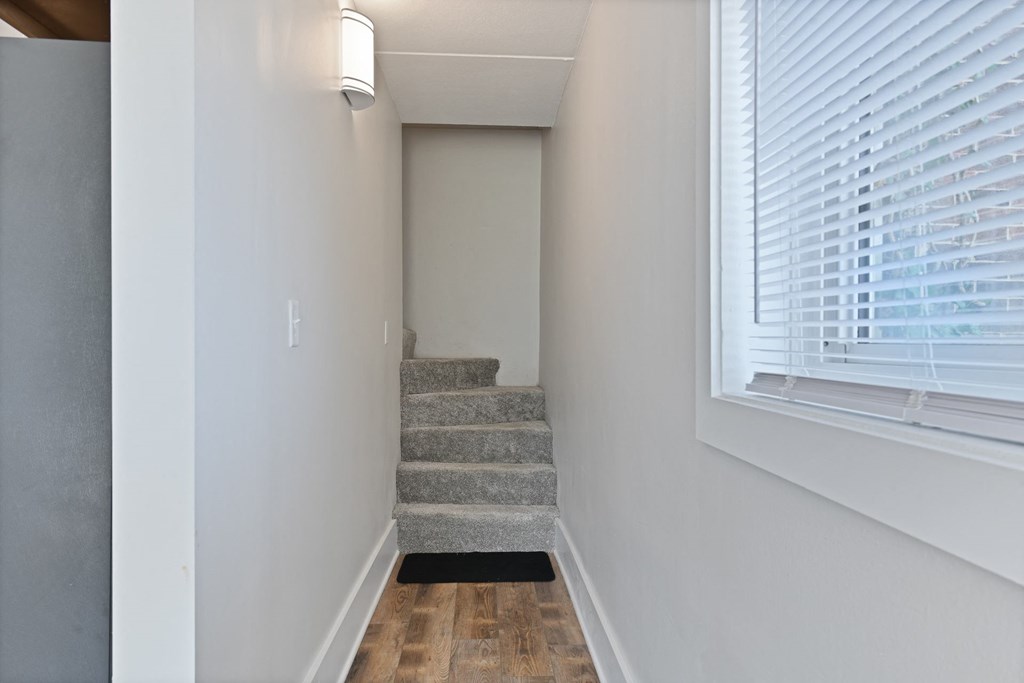 Staircase to the second floor where you can find two bedrooms and a full bathroom at Fox Run Apartments in St Charles IL 60174