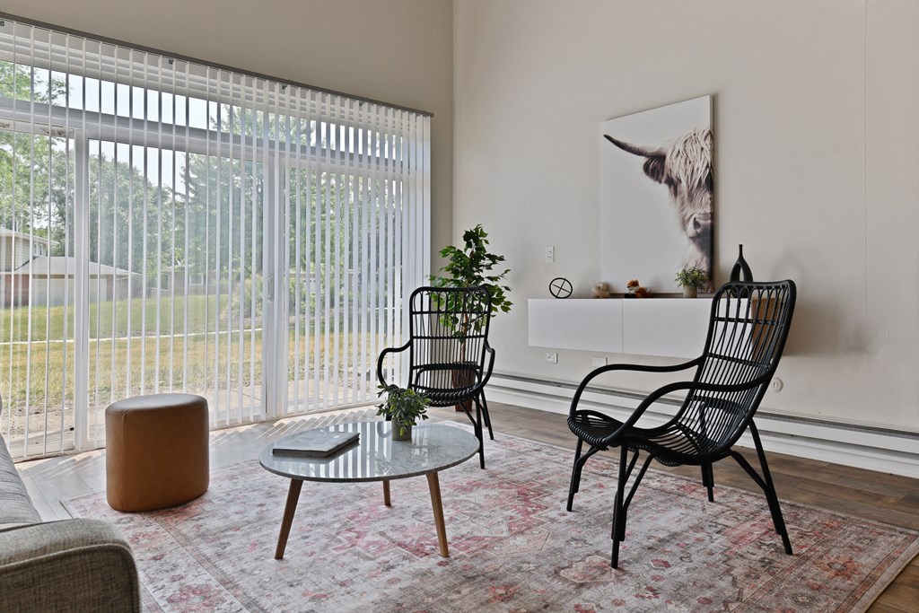Bright view of living room with large sliding door that opens up to the beautiful and private backyard patio at Fox Run Apartments in St Charles IL 60174