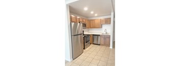 a kitchen with stainless steel appliances and wooden cabinets