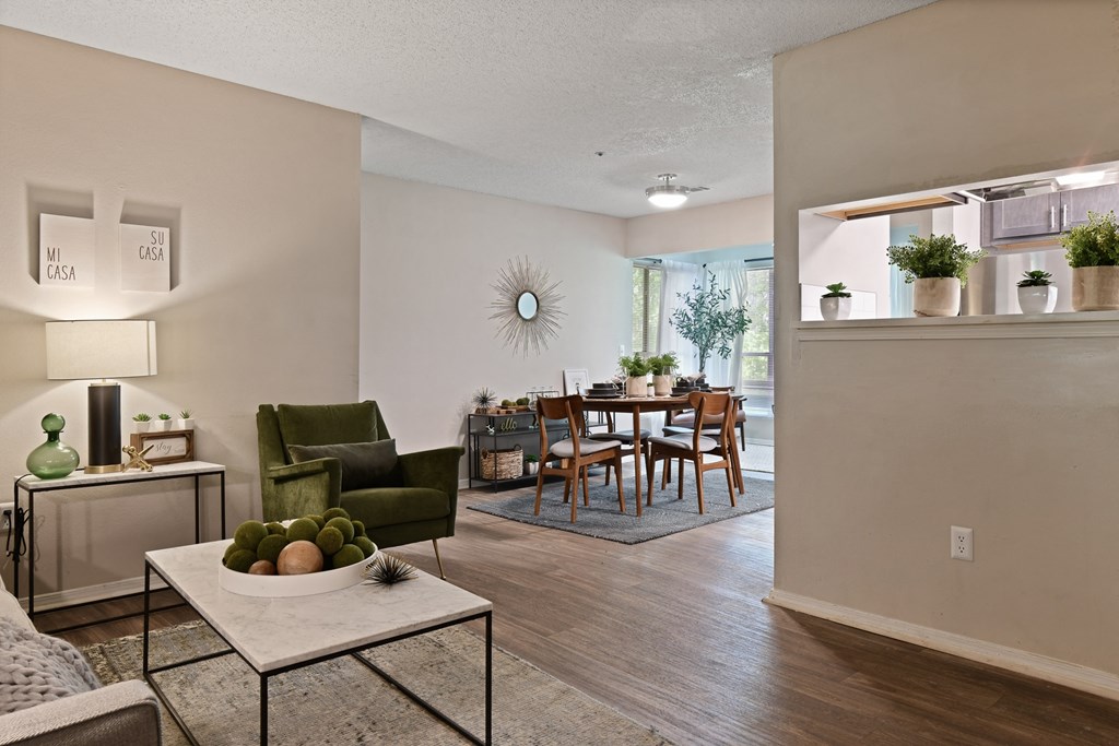a living room with a dining room in the background at 300 Riverside Apartments, Austell, GA