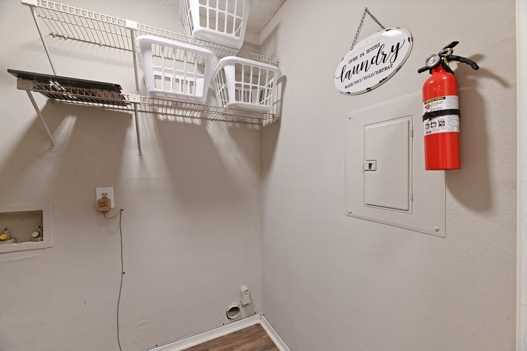 a fire hydrant in the corner of a room with a fire extinguisher on the wall at 300 Riverside Apartments, Georgia