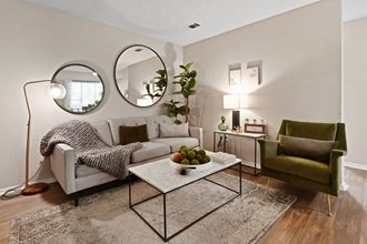 a living room with two mirrors and a couch - Photo Gallery 2