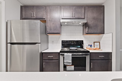 a kitchen with gray cabinets and stainless steel appliances at Waldan Pond Apartments, Acworth, GA, 30102