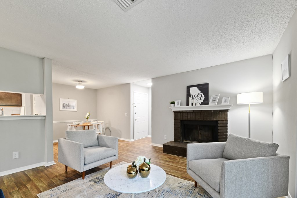 a living room with two couches and a fireplace at Waldan Pond Apartments, Acworth