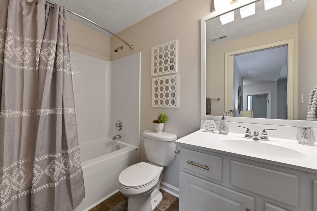 Second bathroom with clean white vanity and large soaking tub at The Reserves of Thomas Glen, Shepherdsville, KY, 40165