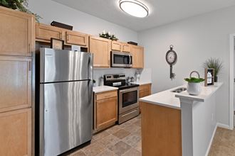 Renovated kitchen with bright lighting and stainless steel appliances at The Reserves of Thomas Glen, Shepherdsville, KY, 40165