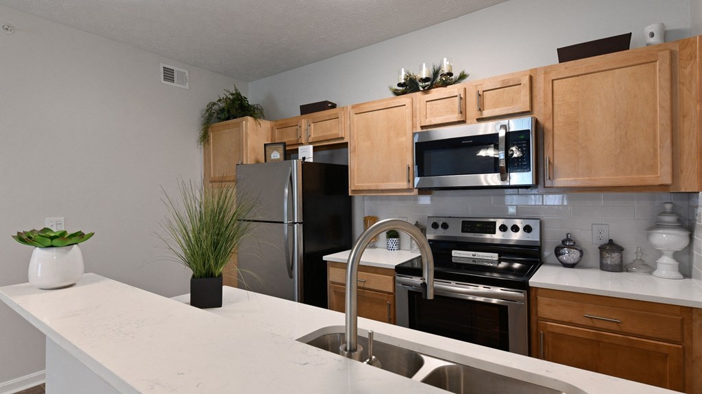 Updated kitchen with clean white countertops and breakfast bar at The Reserves of Thomas Glen, Shepherdsville, KY, 40165