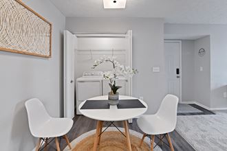 A newly renovated dining room space with laundry room in unit at Trinity Lakes Apartments in Columbus Ohio 43228 - Photo Gallery 4