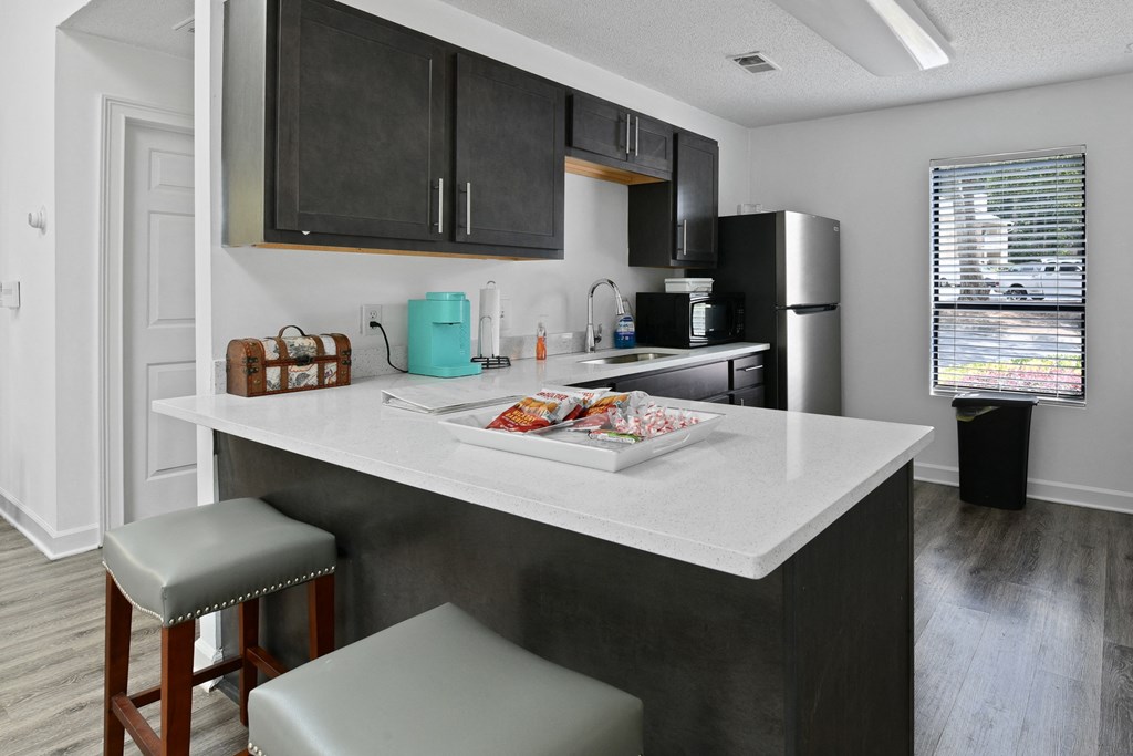 the preserve at ballantyne commons apartment kitchen with island and stools