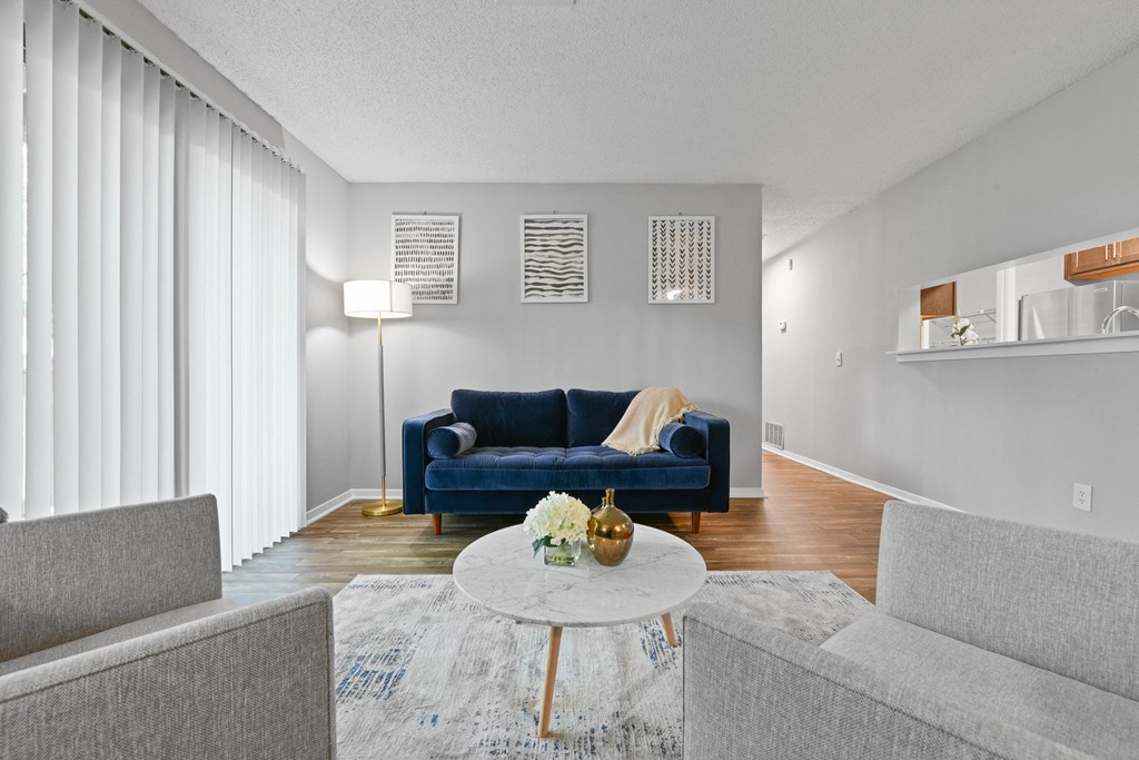 a living room with a blue couch and a white coffee table