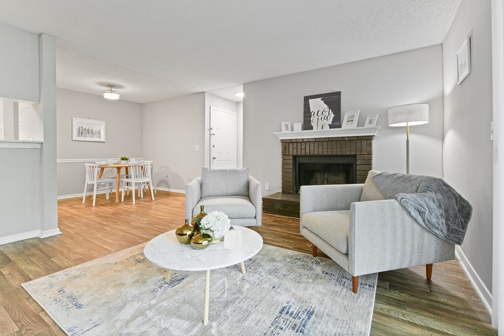 a living room with two chairs and a fireplace