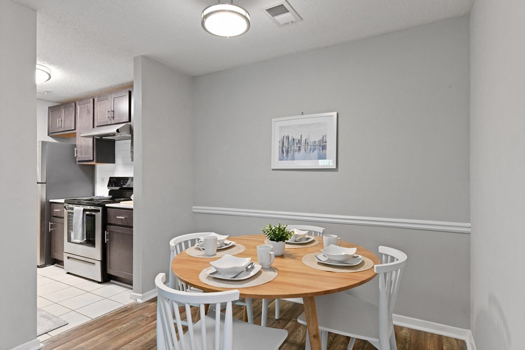 a dining room with a table and chairs and a kitchen