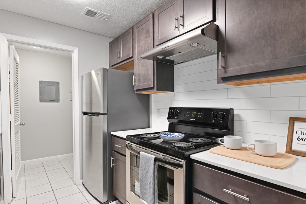 a kitchen with stainless steel appliances and a refrigerator