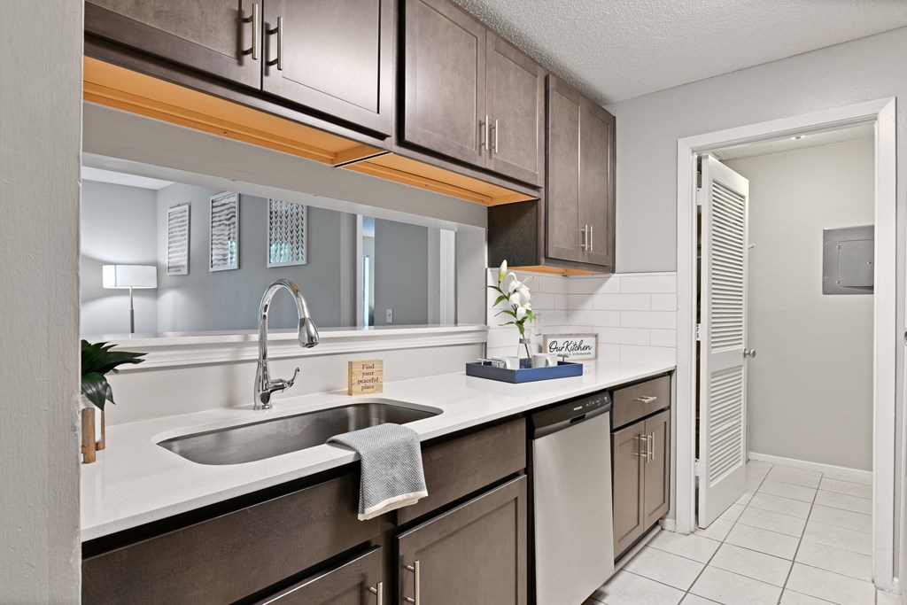 a kitchen with a sink and a window and a door