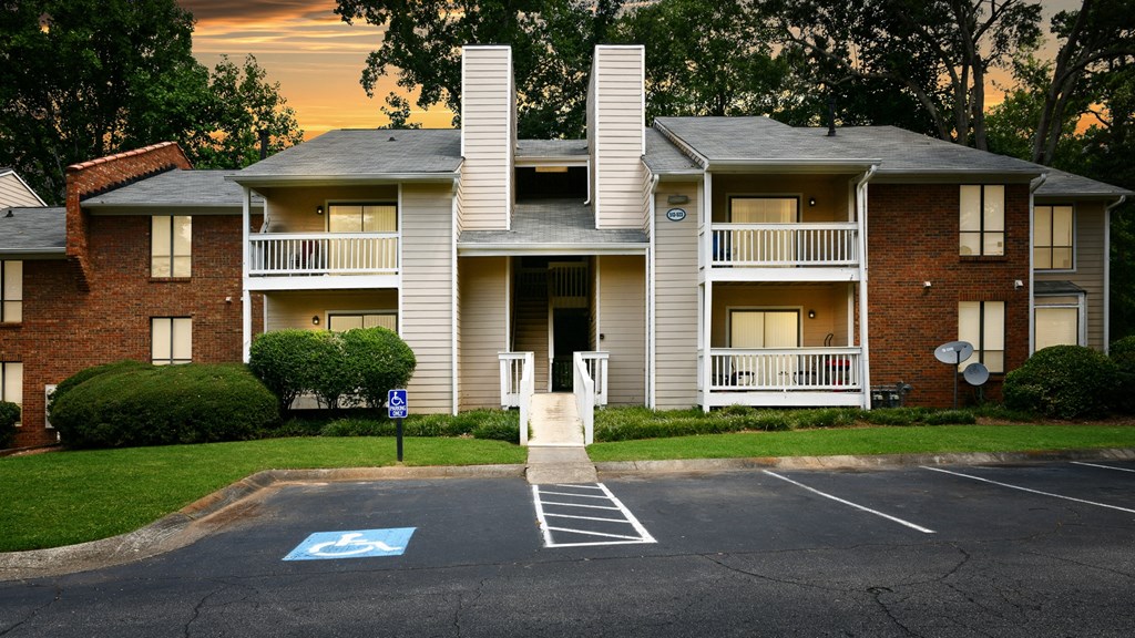 a parking lot in front of an apartment building