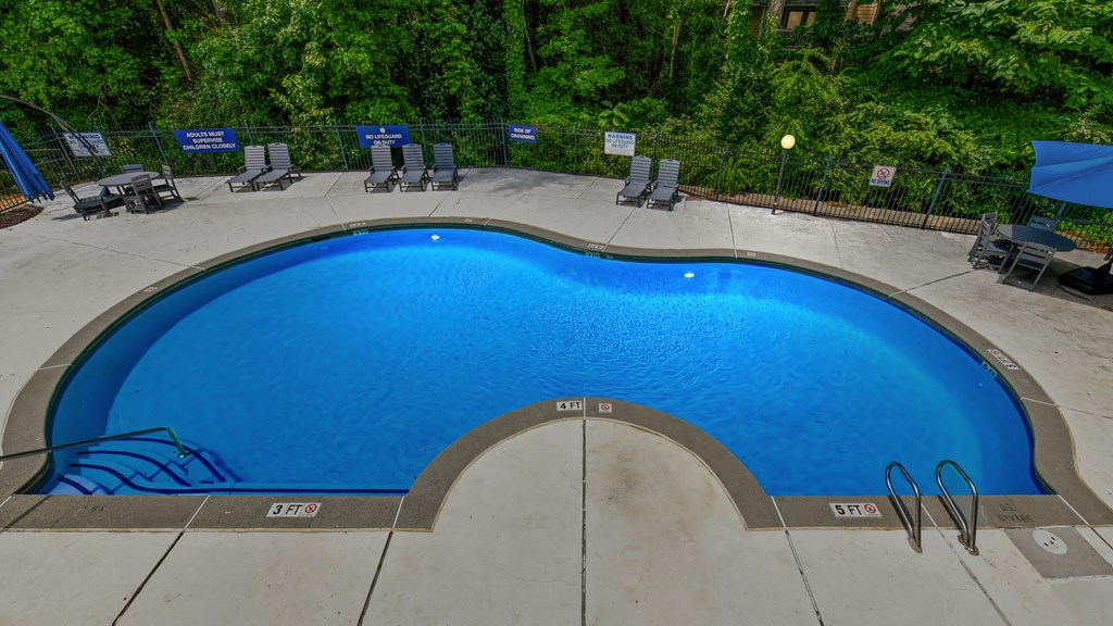 a swimming pool at a resort with a blue pool