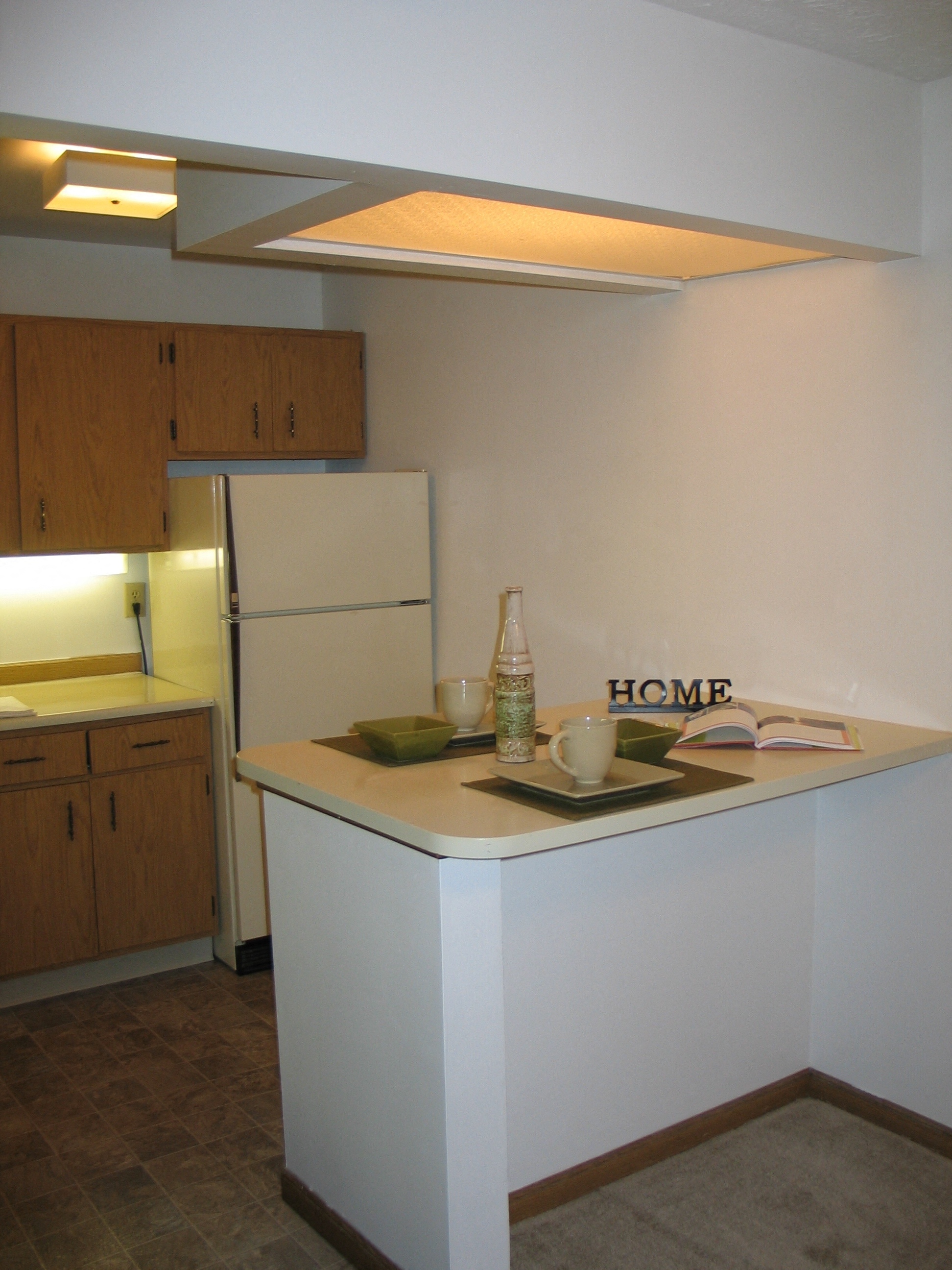 an empty kitchen with a stove and a refrigerator