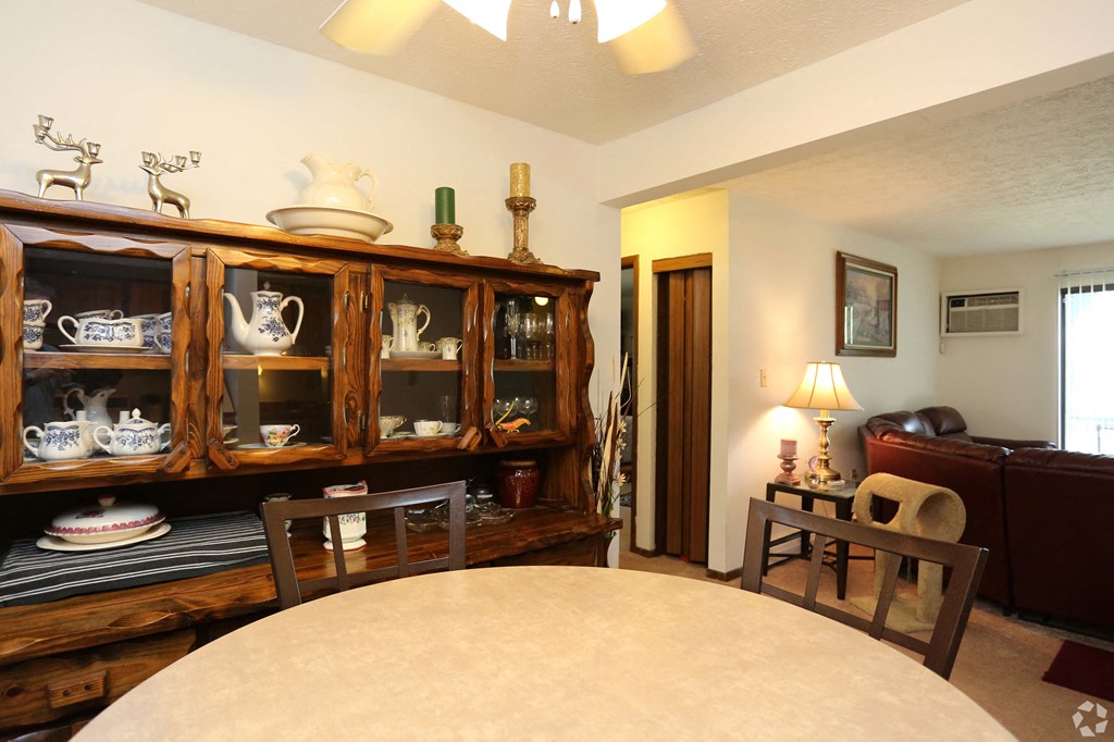 a dining room with a table and a cabinet