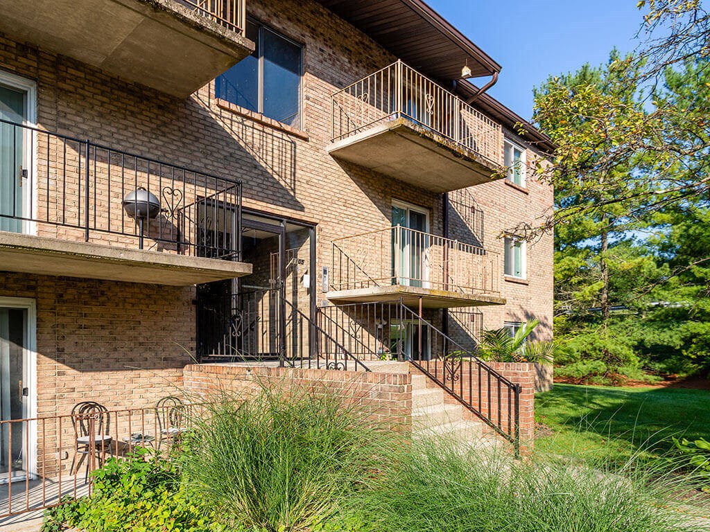 a brick apartment building with two balconies