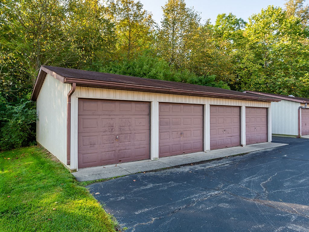 a garage with three garage doors on the side of a building