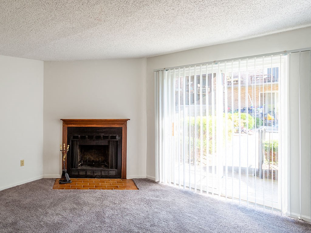 a living room with a fireplace and a large window