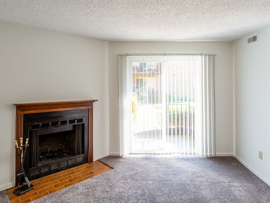 a living room with a fireplace and a sliding glass door