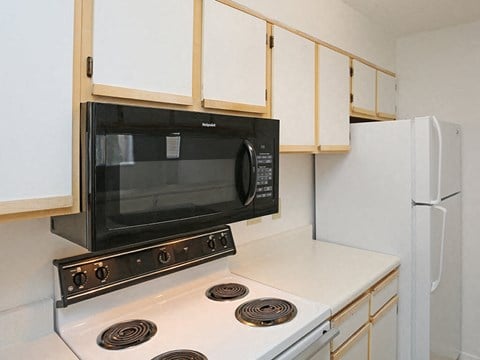 a kitchen with a microwave and a stove