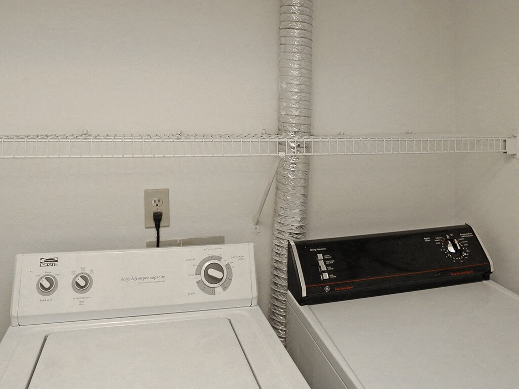 the laundry room has a washer and dryer and a radio