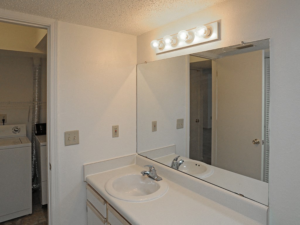 an empty bathroom with a sink and a mirror