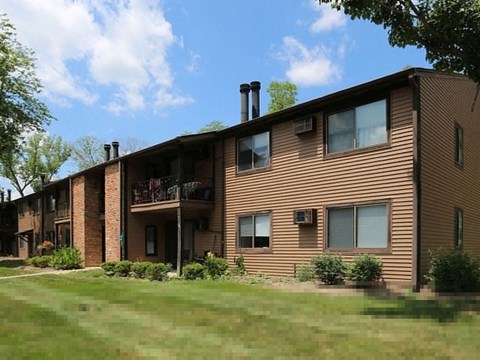 a large apartment building with a yard in front of it