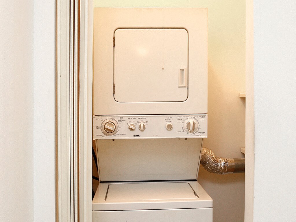 a white washer and dryer in a white room
