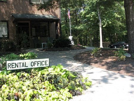 a rental office sign in front of a house