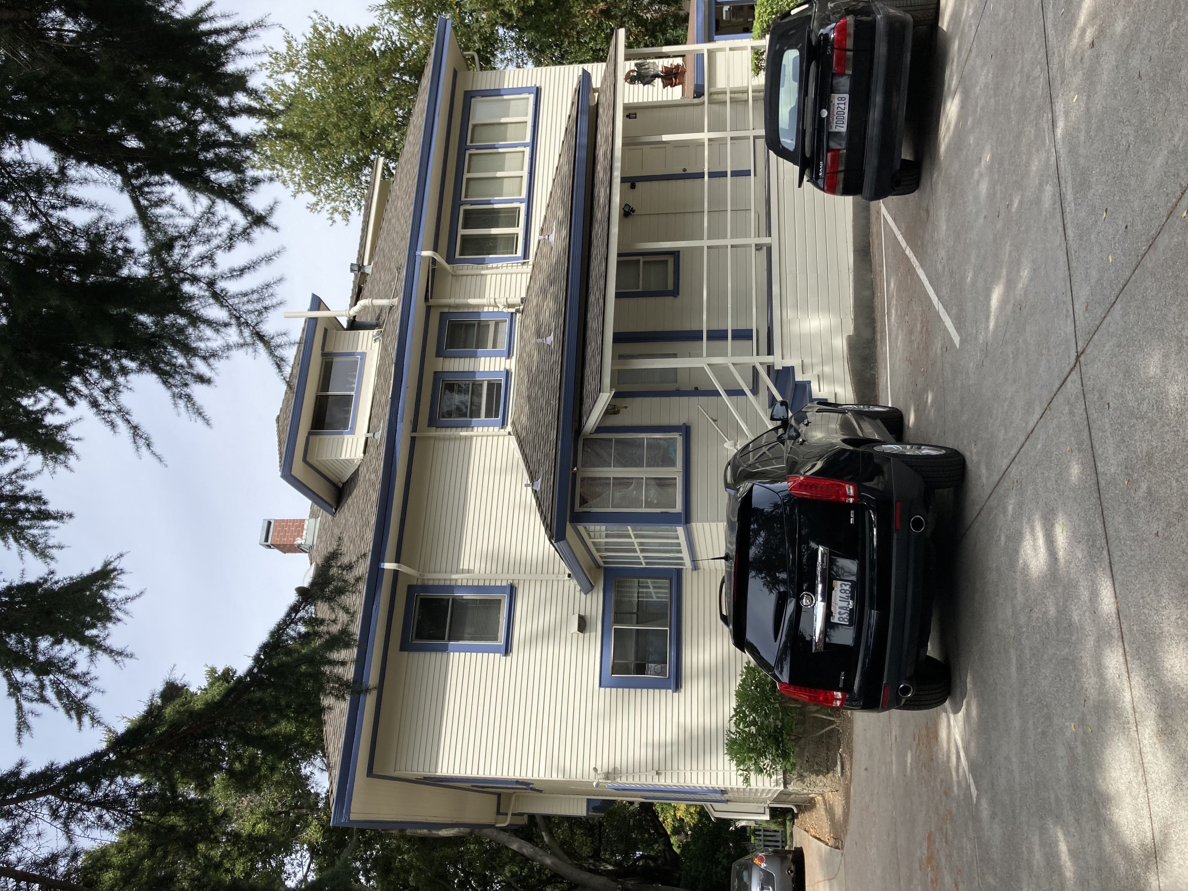 A black car is parked on the side of a street.