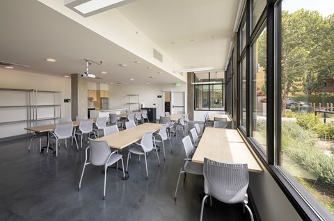 A conference room with a long table and chairs.